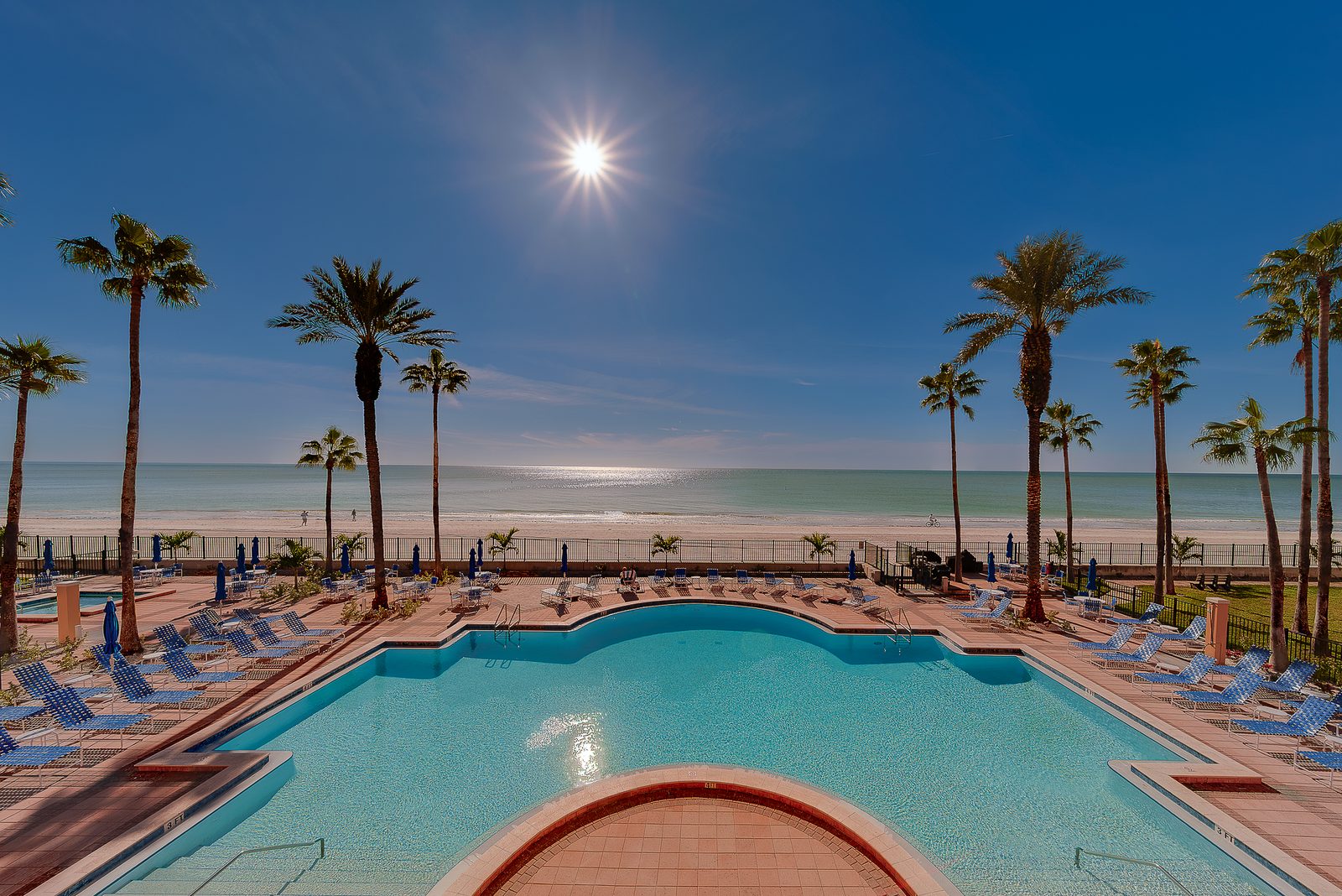 Pool at twilight with palm trees