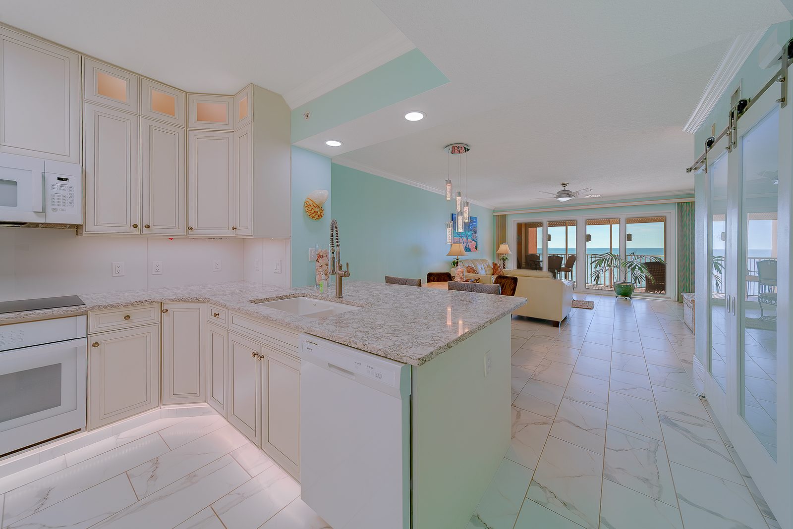 Kitchen with white quartz island and induction cooktop